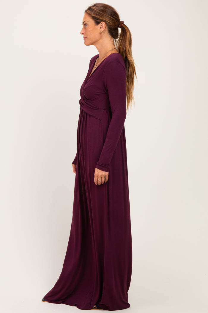 woman wearing a long sleeve purple maxi dress with a twist detail at the waist