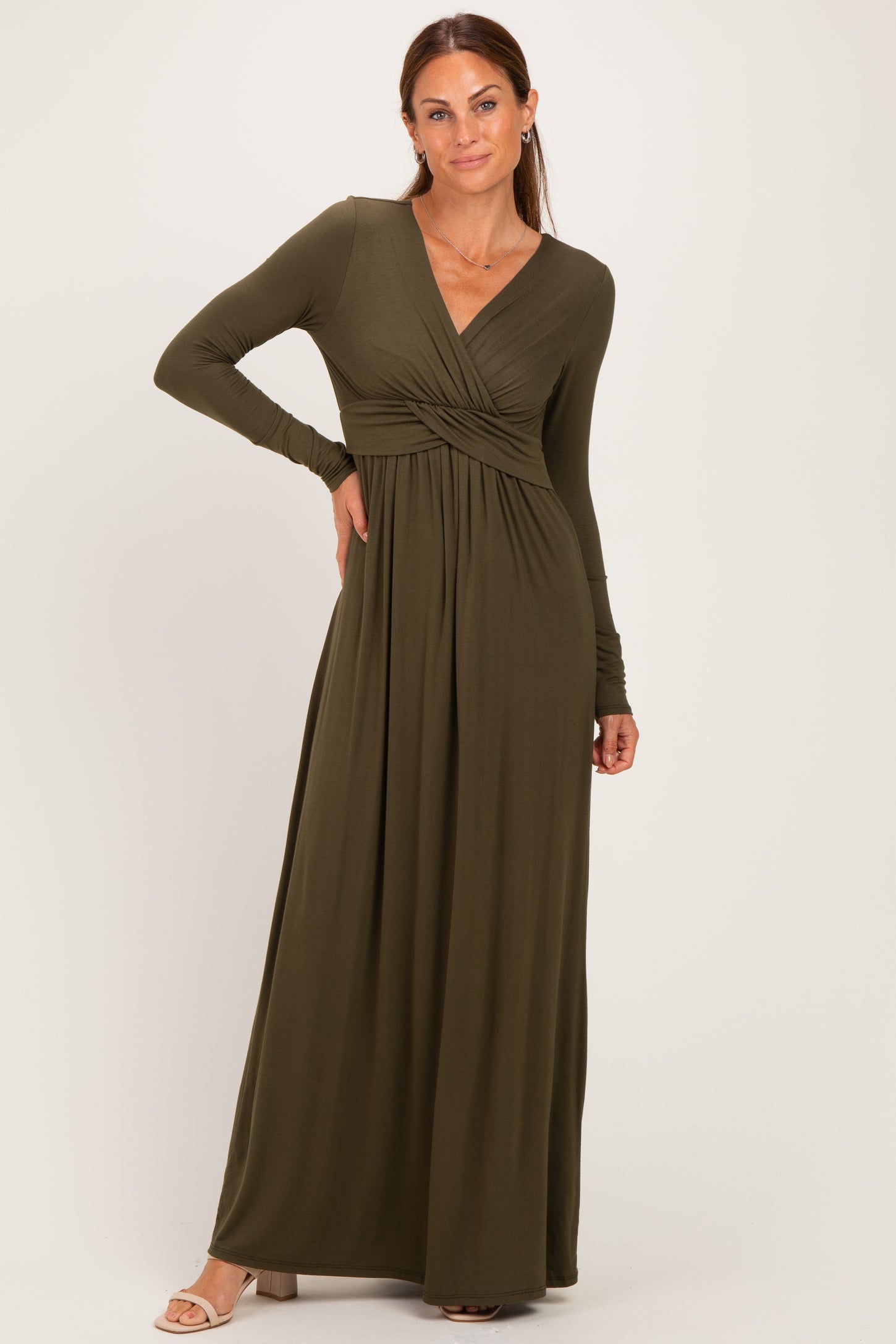 woman wearing a long olive green maxi dress with a wrap front and long sleeves