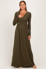 woman wearing an olive green long sleeve maxi dress with a wrapped bodice and pleated skirt
