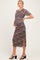 woman wearing a brown leopard print maternity dress with side slits and holding her baby bump