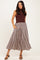 woman wearing a maroon sleeveless top and a striped midi skirt with pockets