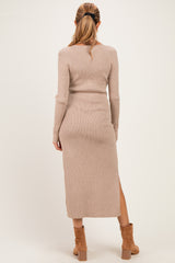 woman wearing a light beige ribbed long sleeve maternity dress with a thigh-high slit, shown from the back