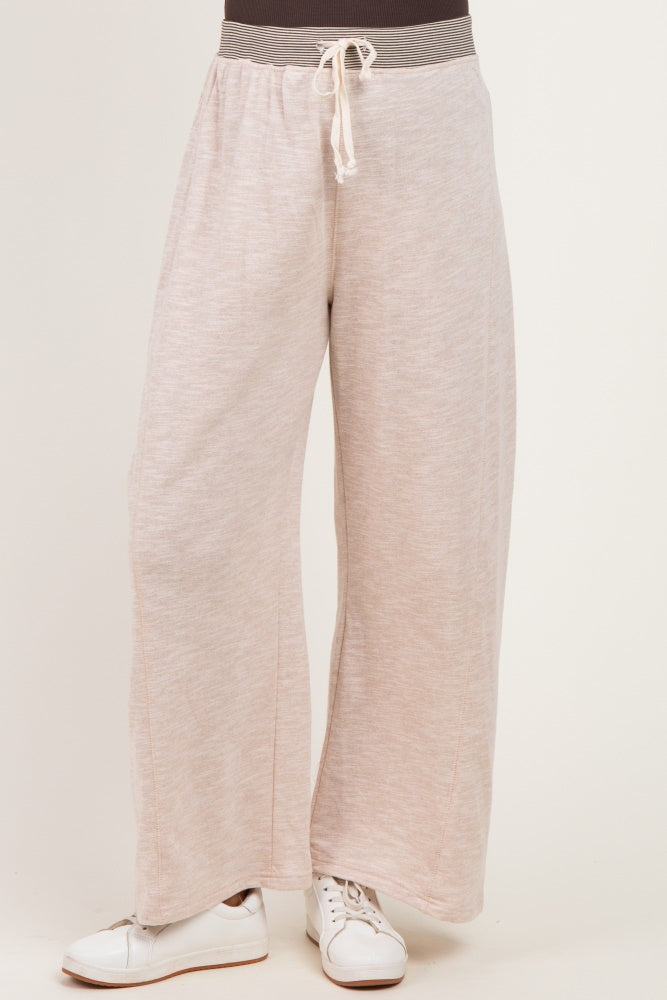 woman wearing light pink wide-leg maternity pants with drawstring waist