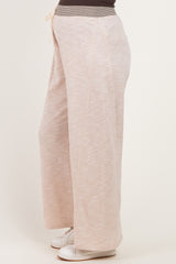 woman wearing light pink wide-leg maternity sweatpants with a drawstring waistband