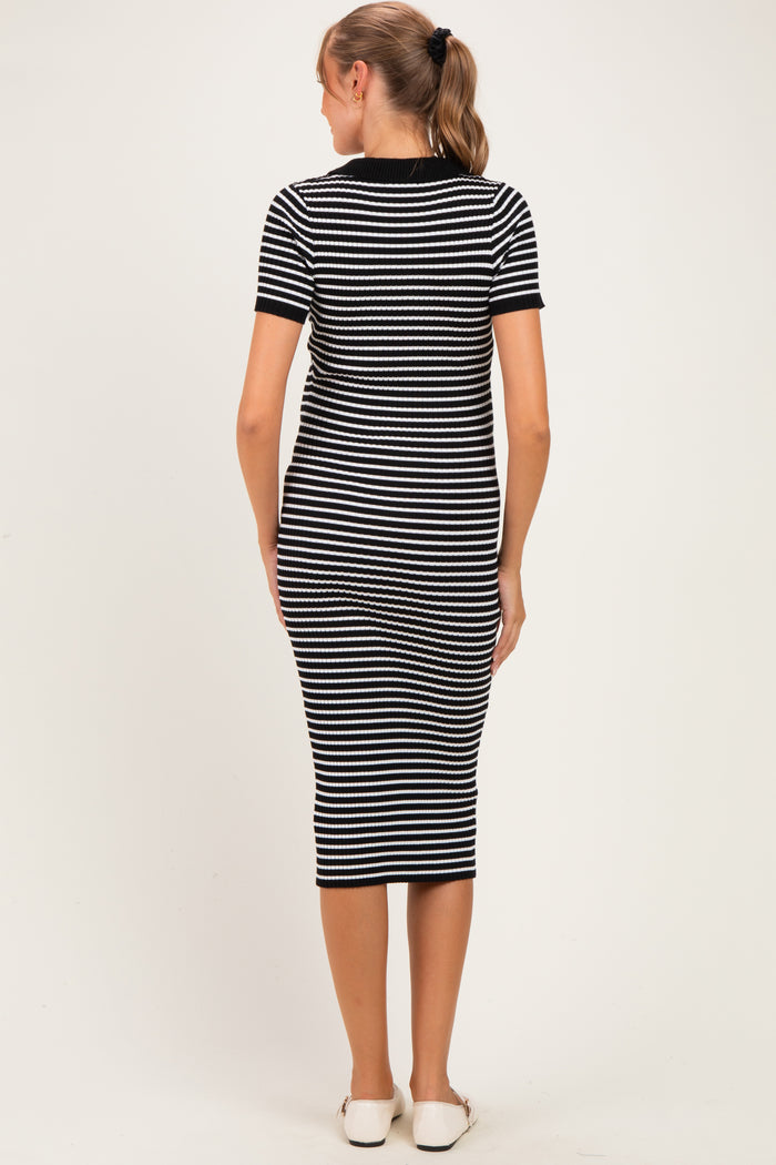 woman wearing a black and white striped maternity dress, seen from the back