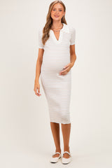 woman wearing a striped white maternity dress with a collar, gently cradling her baby bump