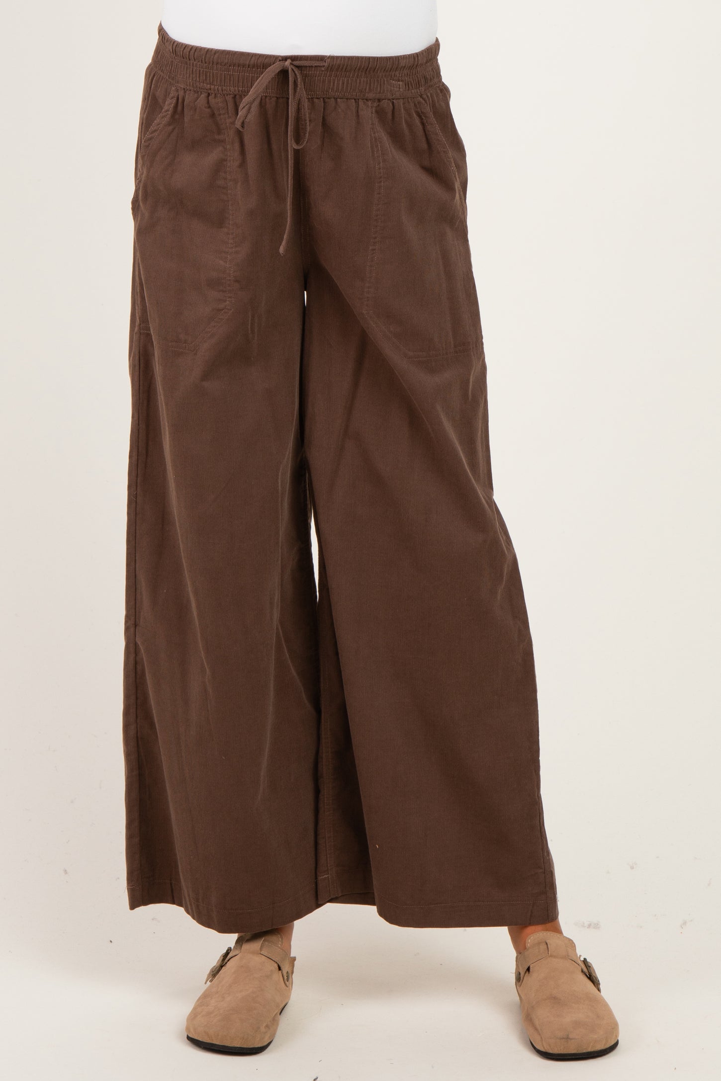 woman wearing brown wide-leg maternity pants with a drawstring waist and pockets