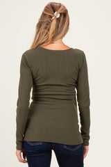 woman wearing an olive green ribbed long sleeve maternity top showing a fitted back style