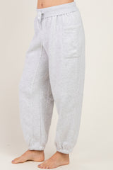 woman wearing light gray relaxed-fit jogger pants with elastic cuffs and side pockets