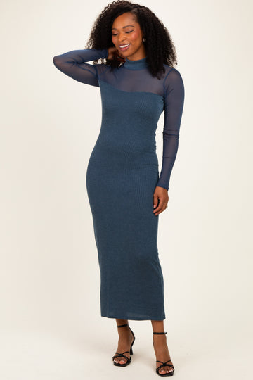 woman wearing a long sleeve dark blue ribbed midi dress with a sheer top and a fitted silhouette