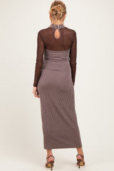 woman wearing a brown striped maternity maxi dress with long sleeves and a keyhole back detail