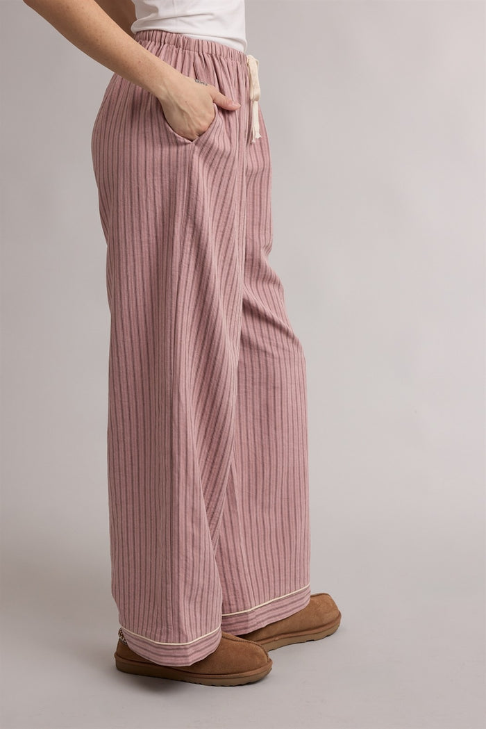 woman wearing pink striped wide-leg lounge pants with pockets and a drawstring waist