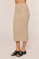 woman wearing a beige ribbed midi skirt and black open-toe mules
