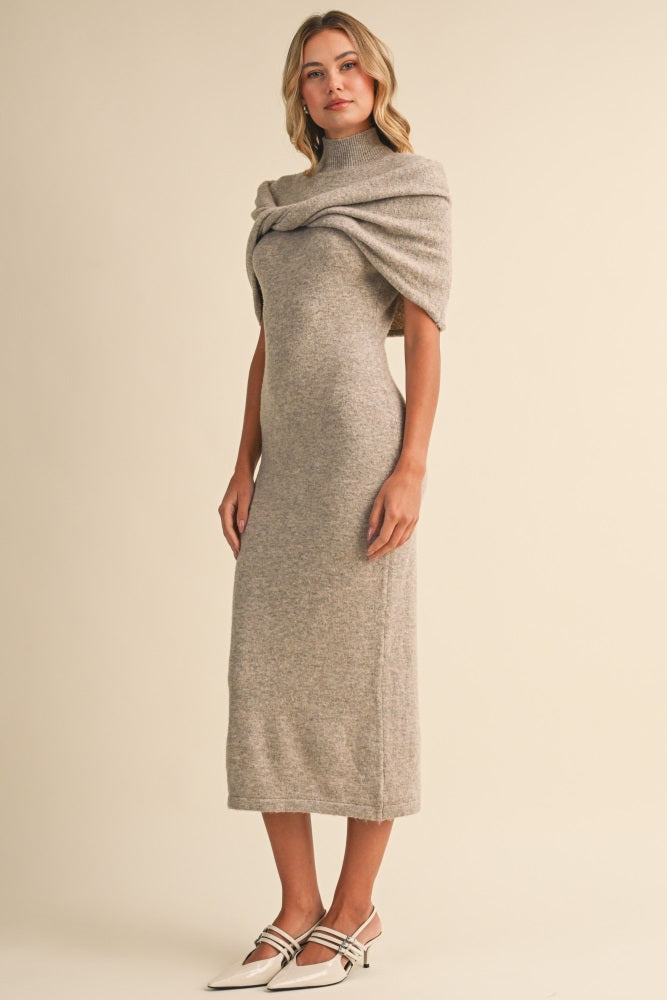 woman wearing a gray midi dress with a high neck and draped detailing, paired with stylish heels