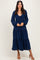 woman wearing a navy blue tiered maxi dress with long sleeves and a front tie detail