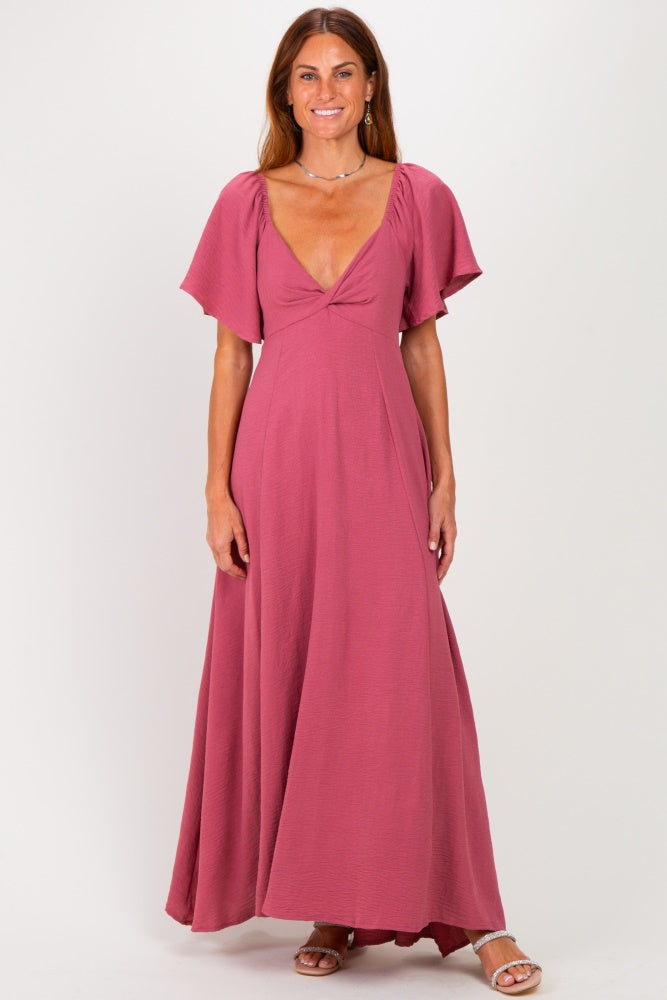 woman wearing a mauve maxi dress with short flutter sleeves and a deep v-neckline