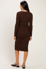 woman wearing a brown ribbed midi dress with long sleeves and a fitted silhouette, viewed from the back