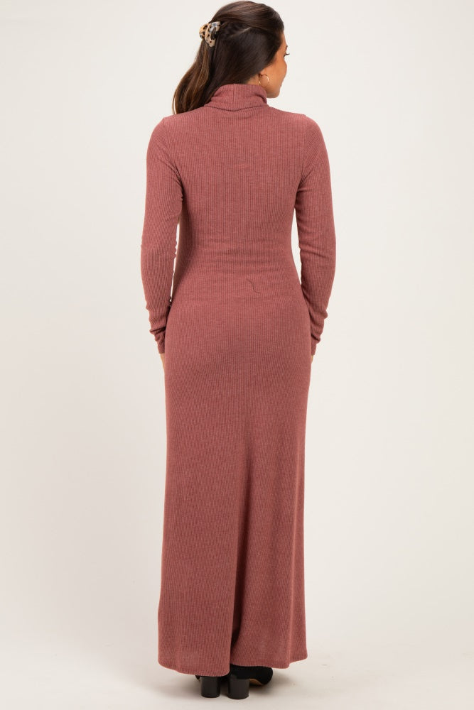 woman wearing a mauve ribbed maternity maxi dress with long sleeves and a high neck, showing a fitted silhouette