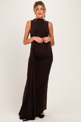 woman wearing a dark brown sleeveless maternity gown with side ruching and a visible baby bump