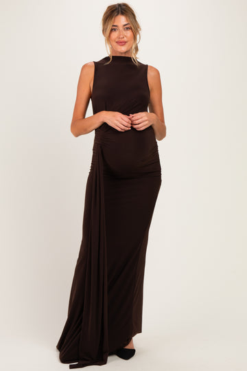 woman wearing a dark brown sleeveless maternity gown with side ruching and a visible baby bump