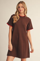 woman wearing a brown short sleeve dress with a red accent on the sleeves