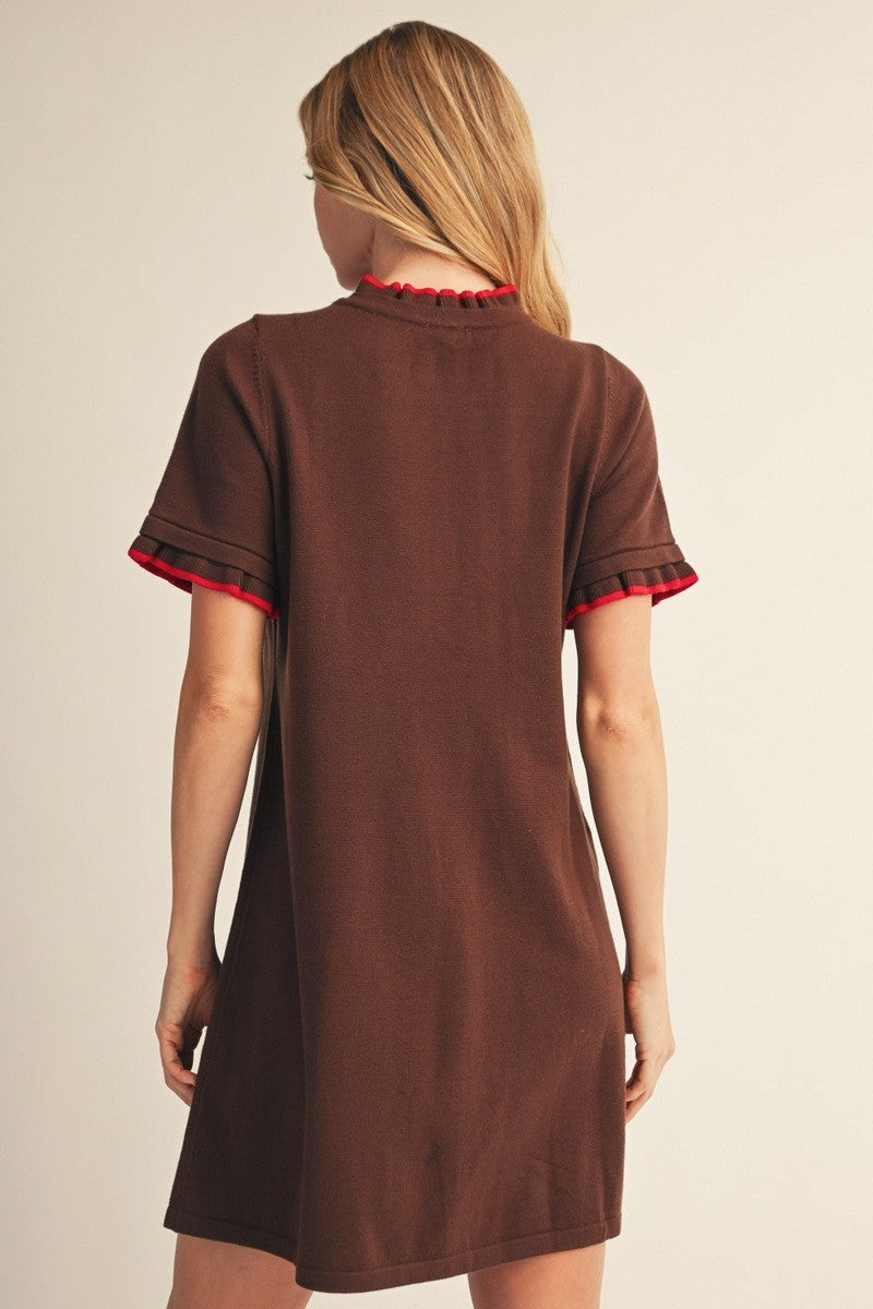 woman wearing a brown short sleeve dress with red trim on the sleeves, viewed from the back