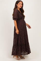 woman wearing a brown lace maternity maxi dress with short sleeves and a visible baby bump