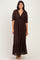 woman wearing a dark brown lace maxi dress with a ruffled neckline and puff sleeves