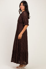 woman wearing a brown lace maxi dress with puff sleeves and a tiered skirt