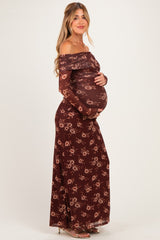 woman wearing a burgundy floral off-the-shoulder maternity dress and holding her baby bump