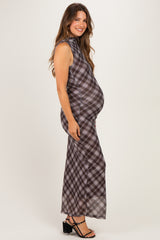 woman wearing a plaid maternity maxi dress featuring a high neckline and a visible baby bump