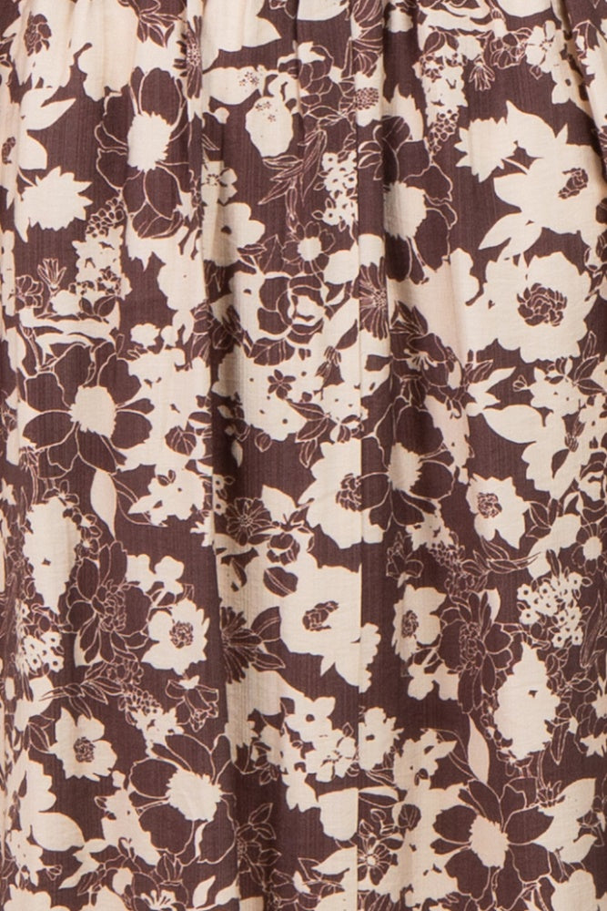 maternity wear in a brown floral print pattern with light beige flowers, showing soft fabric and gathered details