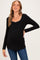 woman wearing a black long sleeve maternity top with a scoop neckline and a slight shimmer trim, showing her baby bump