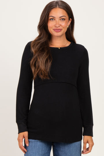 woman wearing a black long sleeve maternity top with a flattering empire waistline and casual style