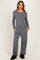 woman wearing a gray maternity loungewear set with a long sleeve henley top and wide-leg pants, model with a baby bump