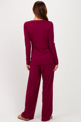 woman wearing a burgundy long sleeve top and matching wide-leg pants, seen from the back
