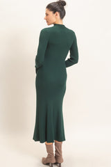 woman wearing a dark green ribbed long sleeve dress with a flared hem and back view visible
