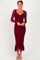 woman wearing a burgundy long sleeve fitted midi dress with ruffle hem and a front twist detail