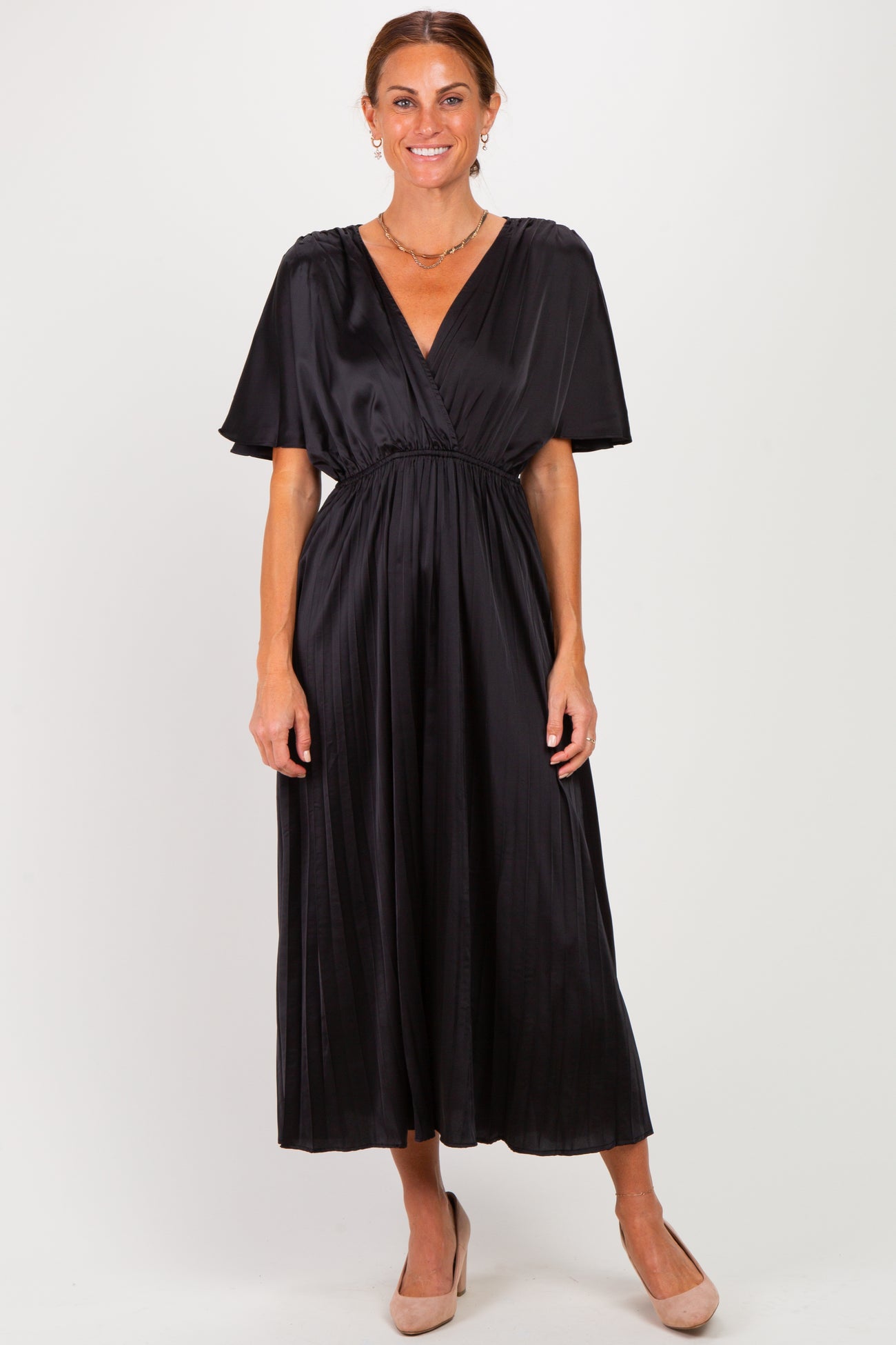 woman wearing a black satin maxi dress with a deep v-neck and short flutter sleeves, standing in a neutral pose
