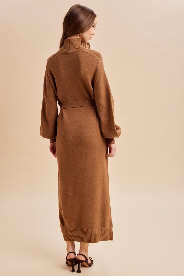 woman wearing a brown long sleeve knitted maxi dress with a belt, showing the back view