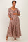 woman wearing a pink floral maternity maxi dress with puff sleeves and holding her baby bump