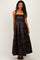 woman wearing a black floral print maternity maxi dress with adjustable straps and a fitted bodice