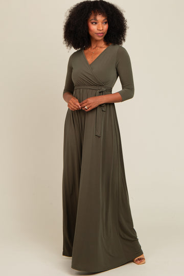 woman wearing an olive green long sleeve wrap maxi dress with a tied waist detail