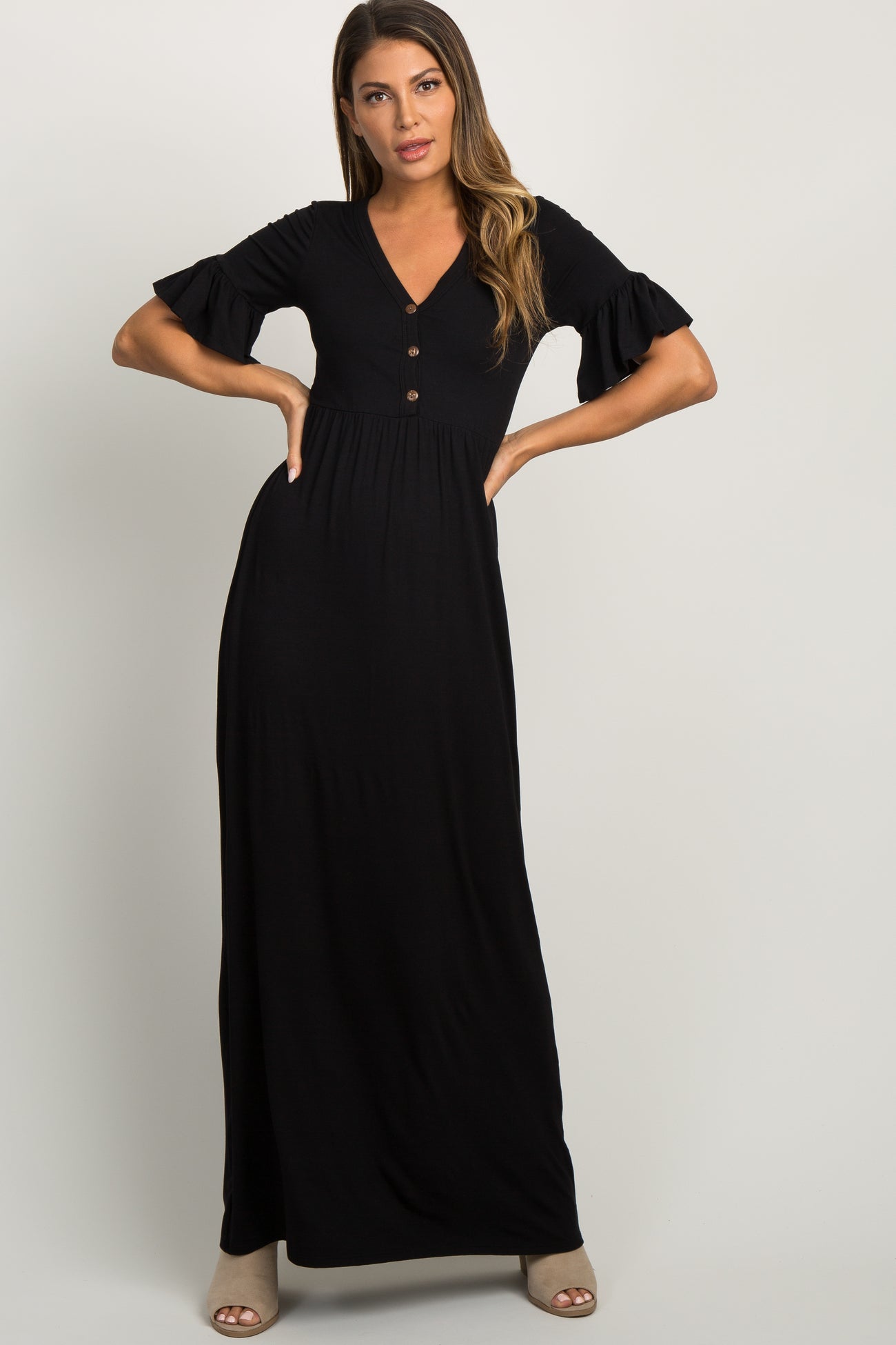 woman wearing a black short sleeve button front maternity maxi dress with ruffle sleeves