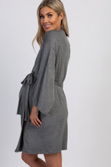 woman wearing a gray maternity robe with a belt and bell sleeves, showing her baby bump from the side