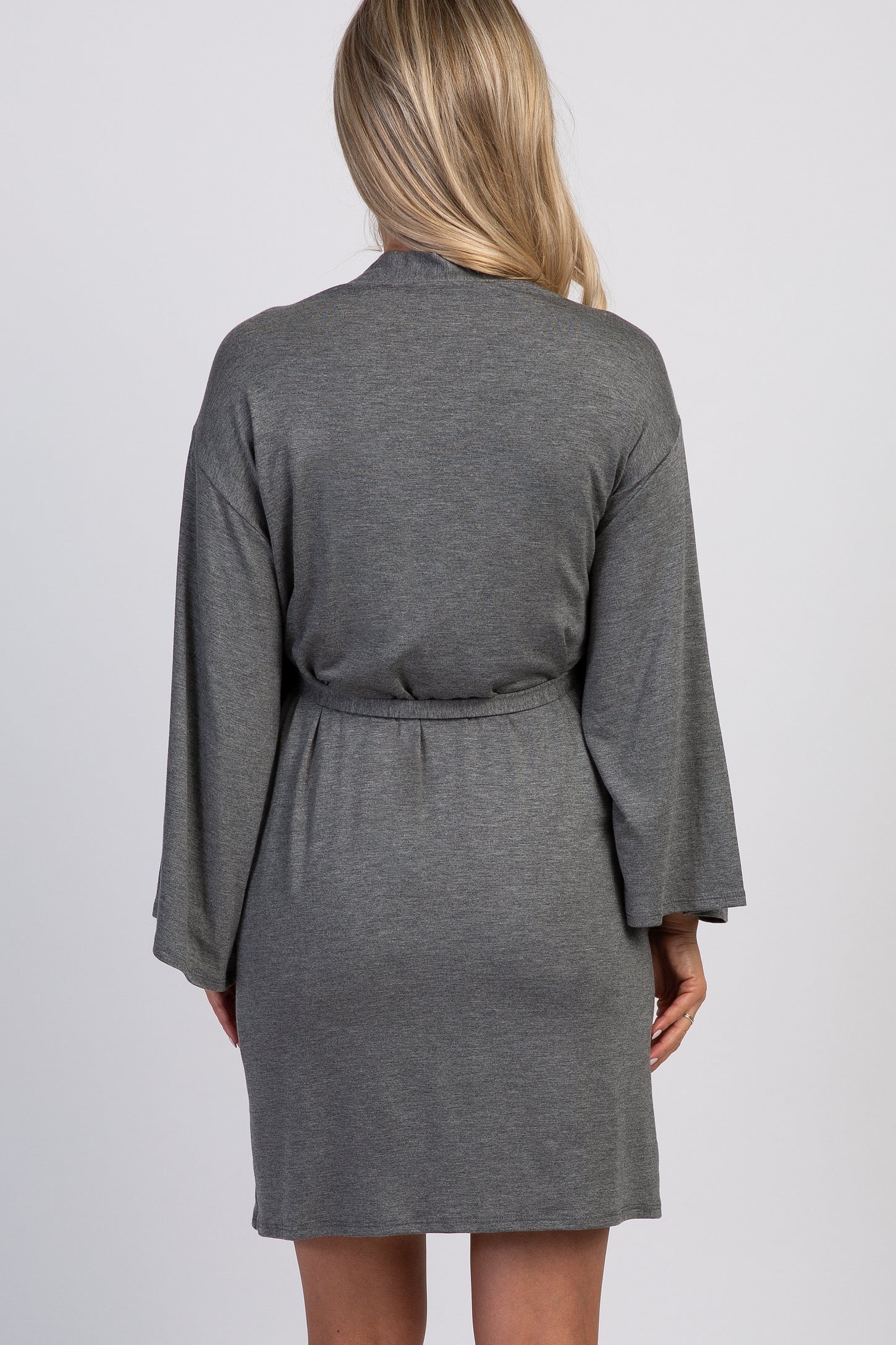 woman wearing a gray maternity robe with bell sleeves and a tie belt, shown from the back
