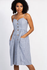 woman wearing a blue and white striped midi dress with buttons and pockets against a white background
