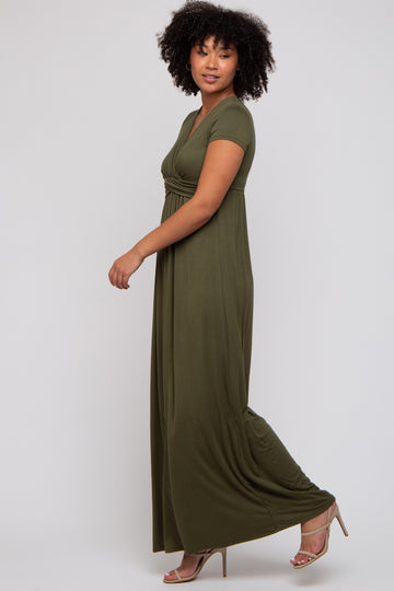woman wearing a short sleeve olive green maxi dress, standing sideways with a relaxed pose