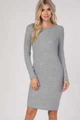 woman wearing a light gray ribbed long sleeve dress with a fitted silhouette