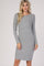 woman wearing a light gray ribbed long sleeve dress with a fitted silhouette